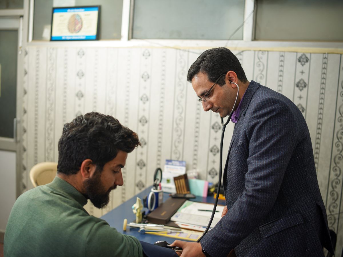 A doctor consulting a patient at the clinic desk